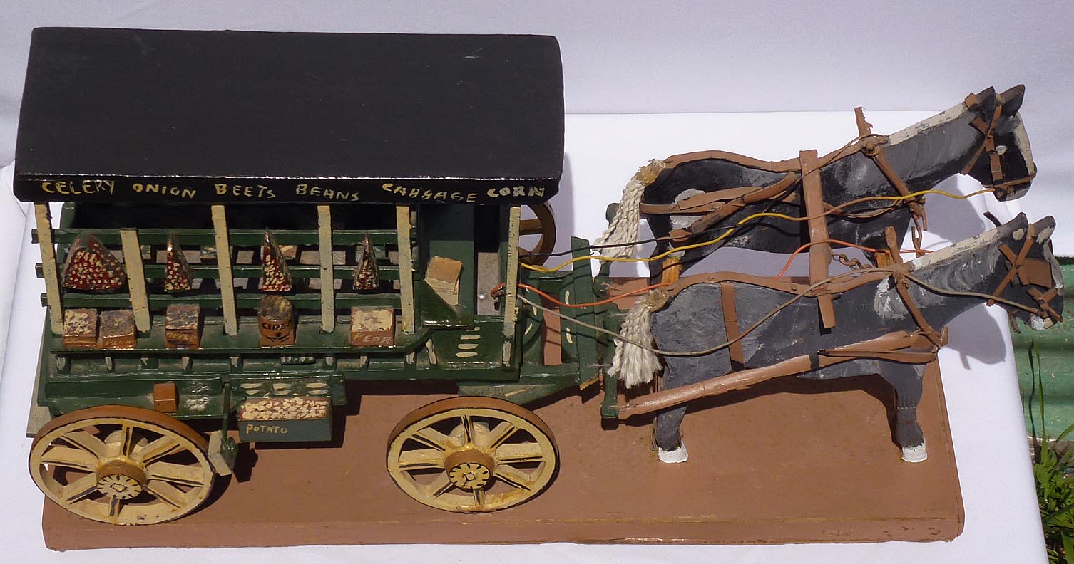 Carved farm wagon by Jim Popso