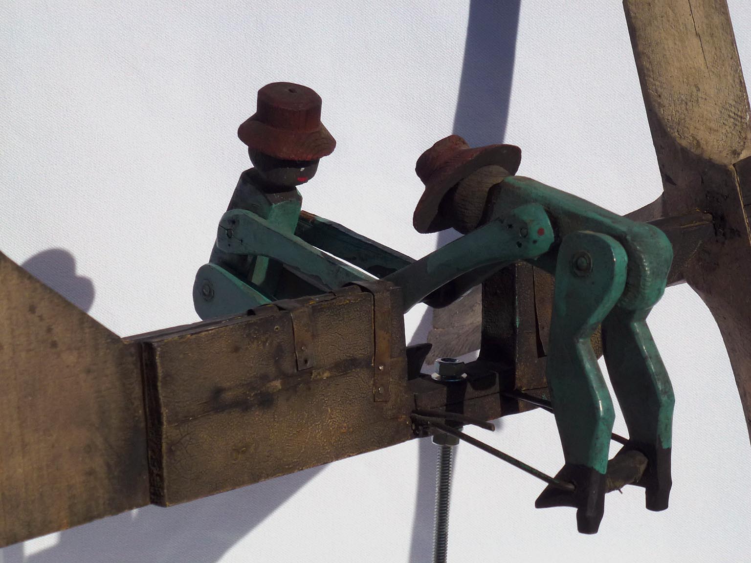 Whirligig of Two Figures Turning a Crank