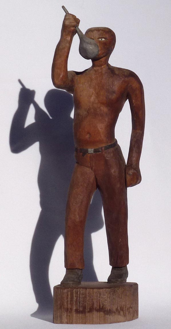 Carving of man drinking from ladle