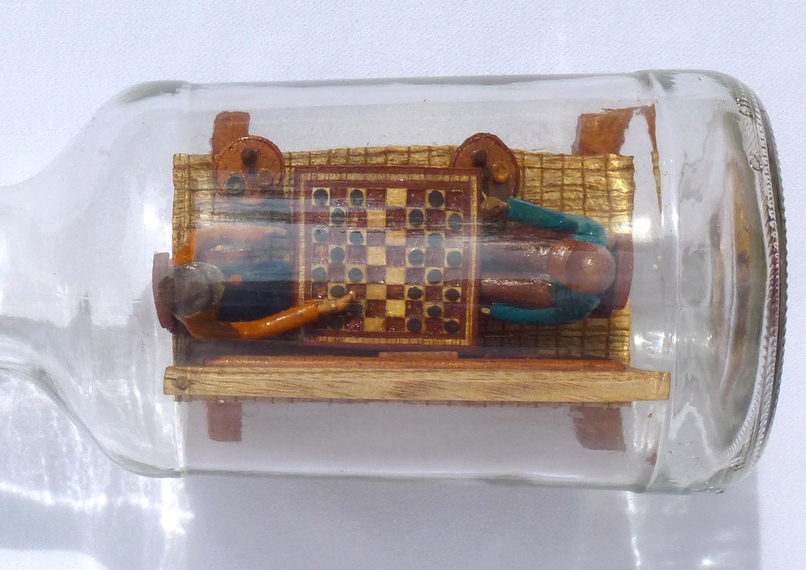 Intricate Bottle Whimsey of Men Playing Checkers