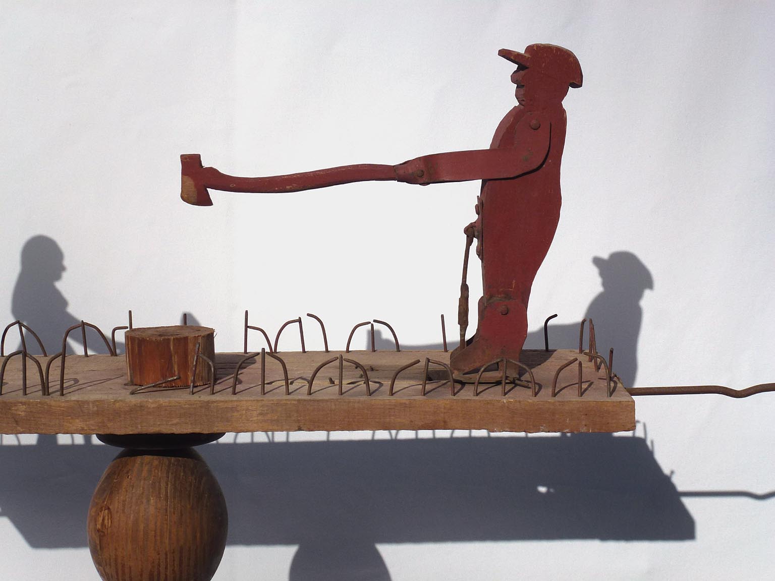 Whirligig of man chopping, woman washing