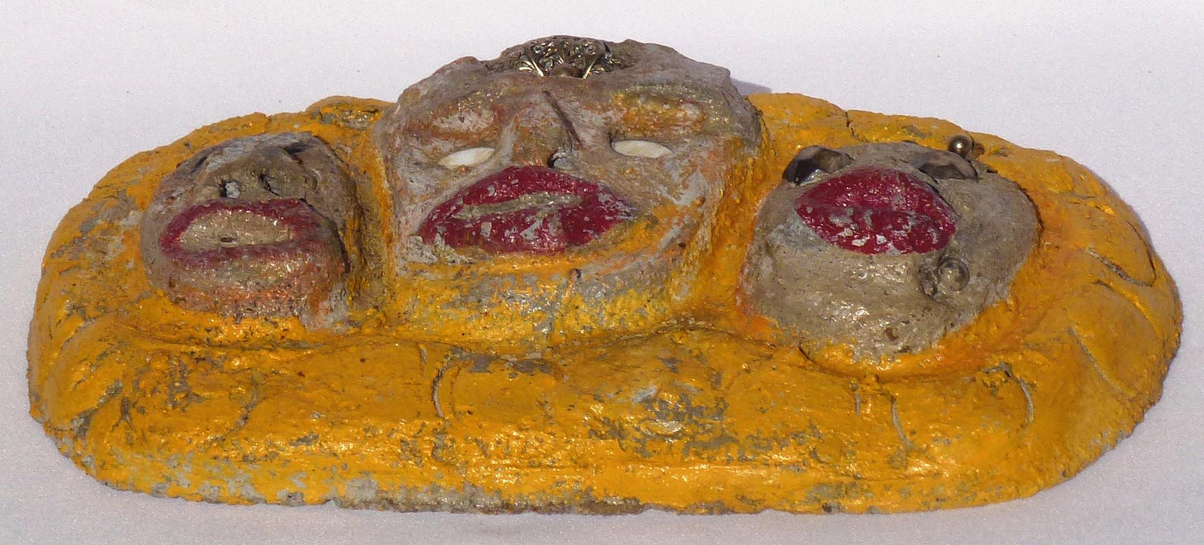 Outsider art concrete faces