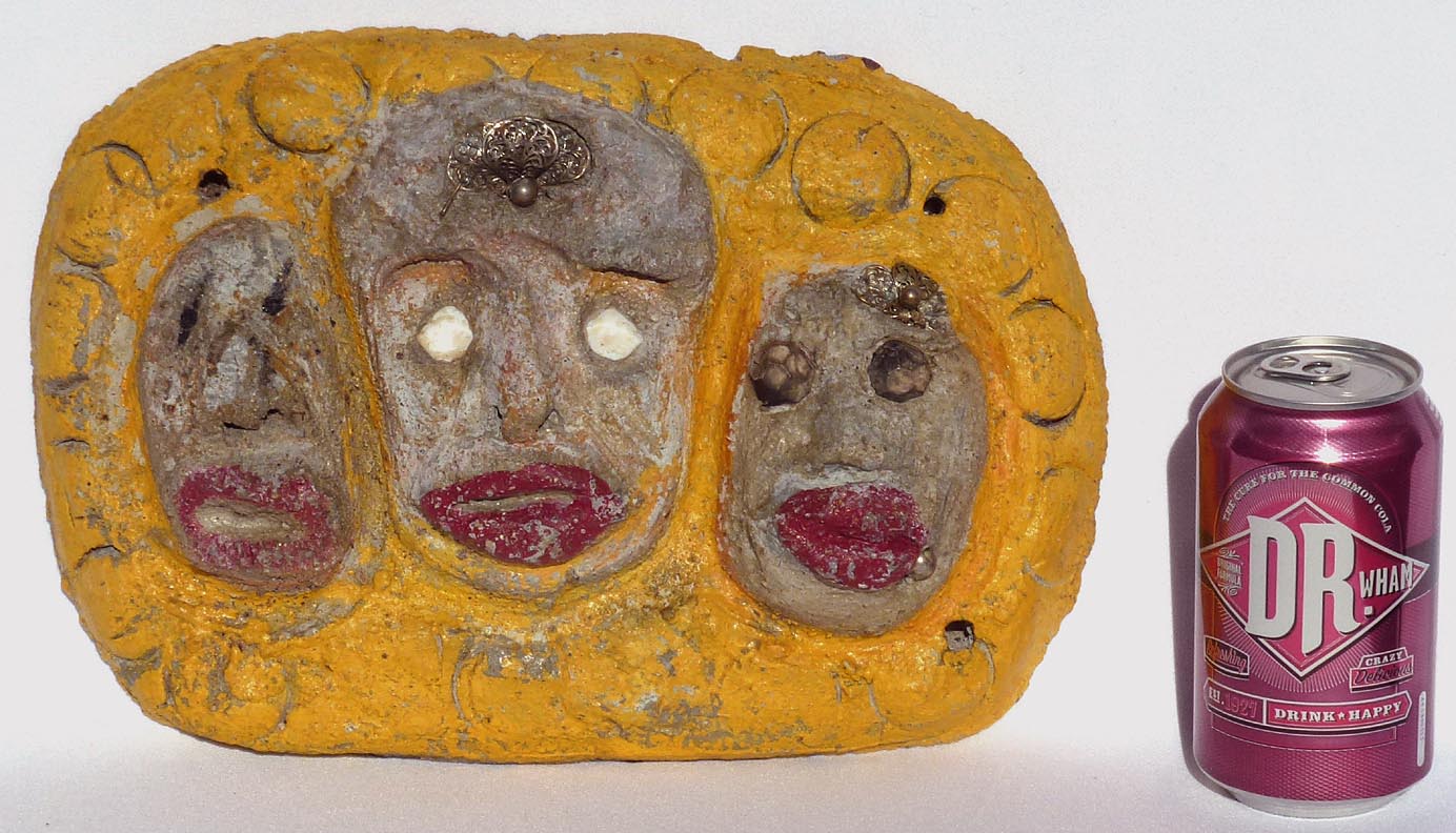 Outsider art concrete faces