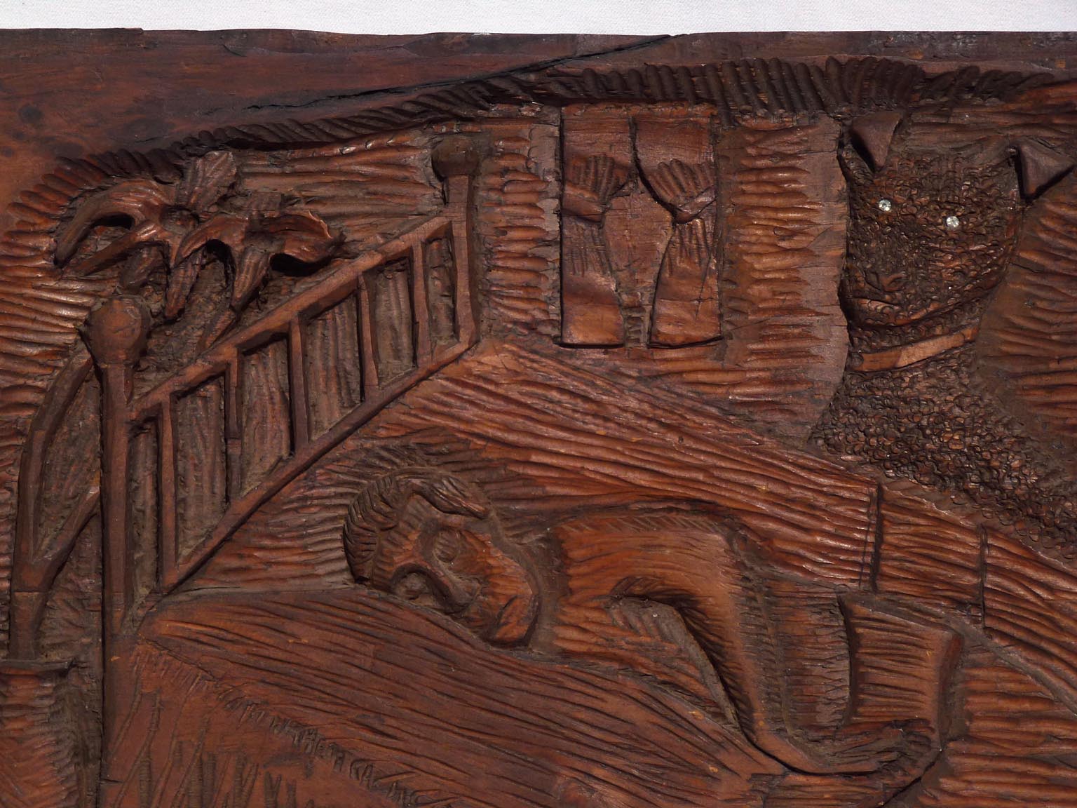 Carving of sleeping man with dog