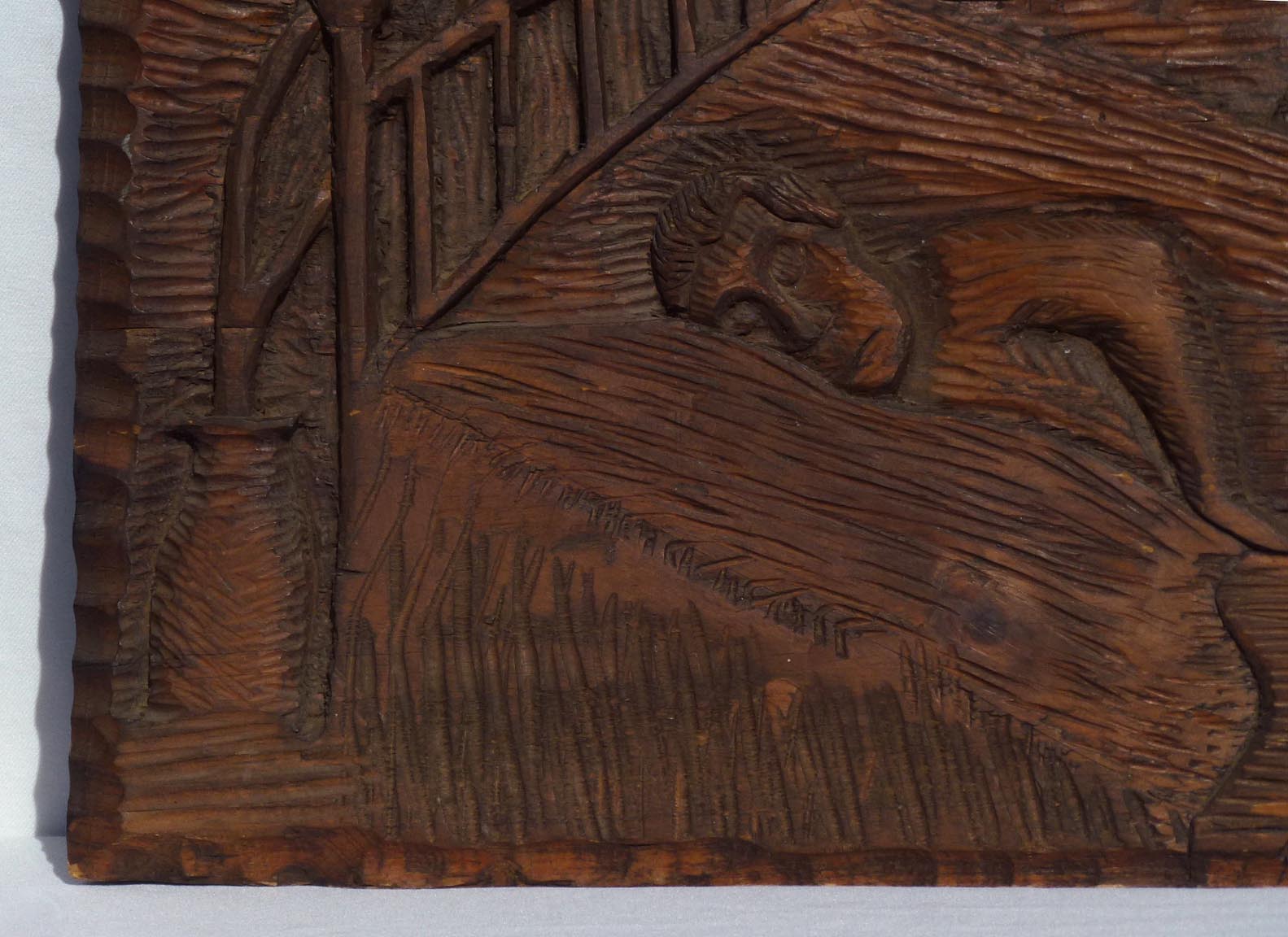 Carving of sleeping man with dog