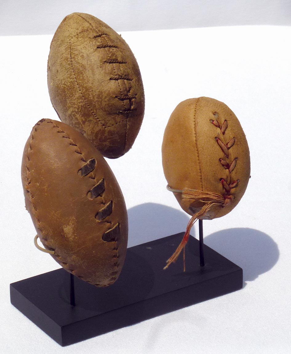 Three hand made miniature footballs