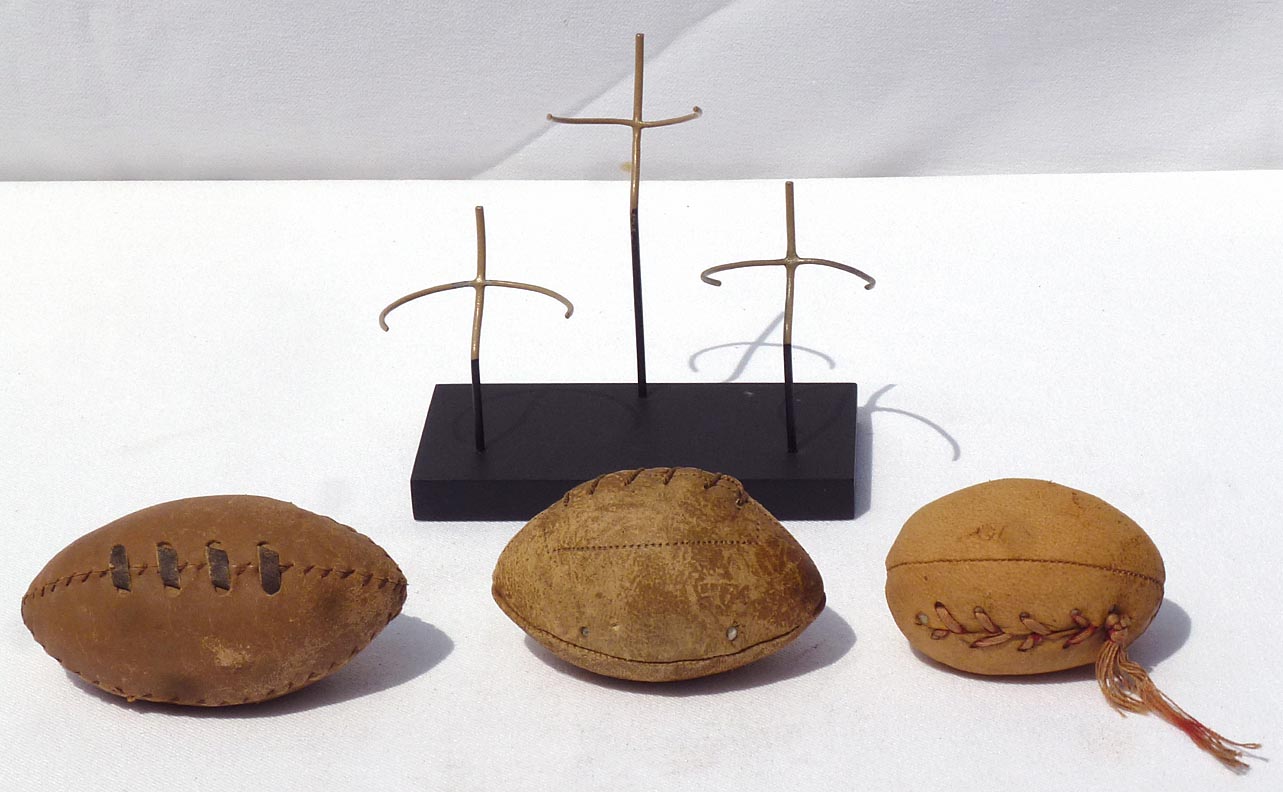 Three hand made miniature footballs