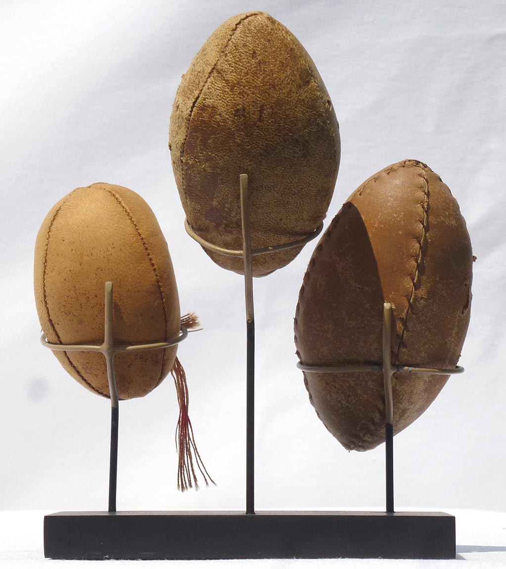 Three hand made miniature footballs